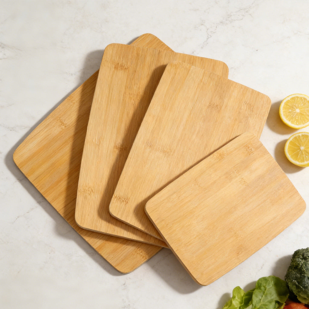 Four-piece bamboo cutting board set fanned out on a white background